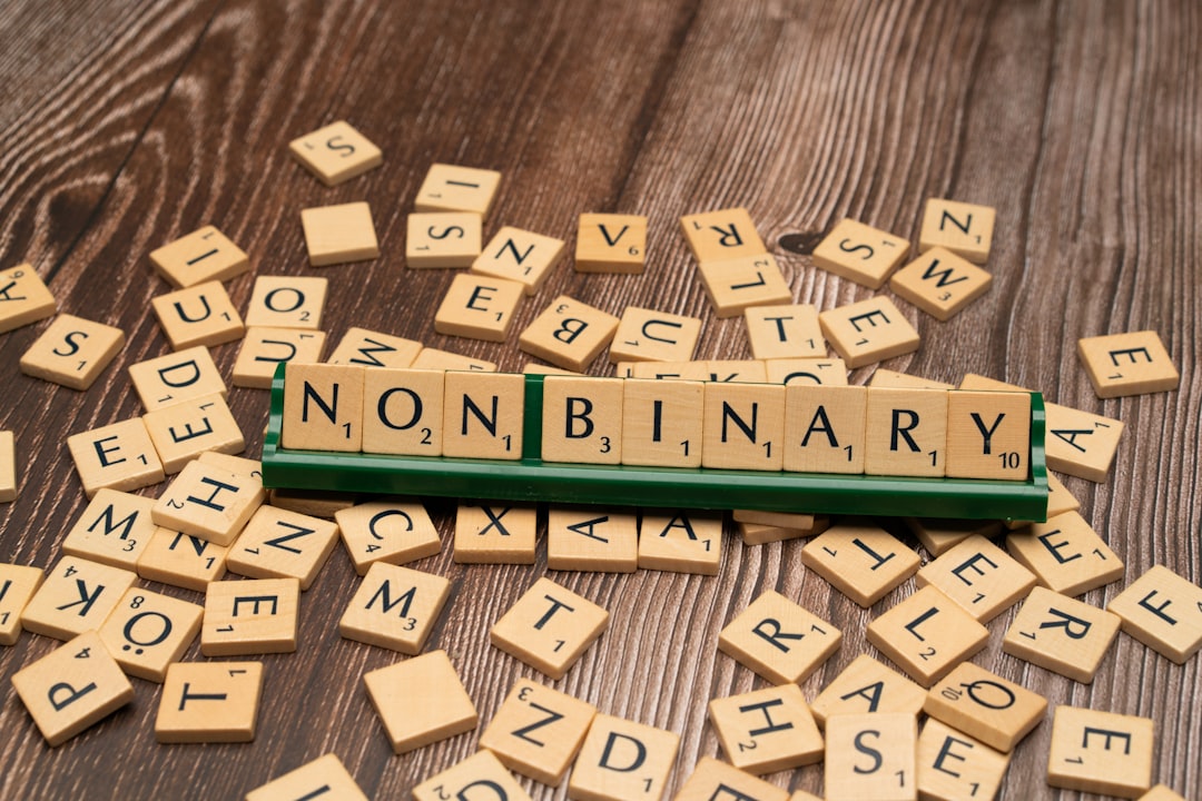 scrabble-tiles-spelling-the-word-non-military-on-a-wooden-table-c536kv-t-b4